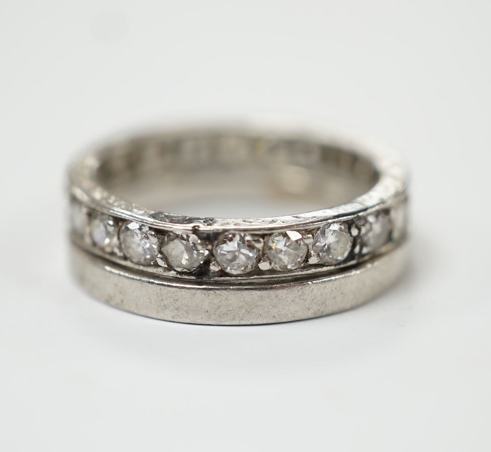 A white metal and diamond set full eternity ring, size K and an unmarked white metal band. Fair condition.